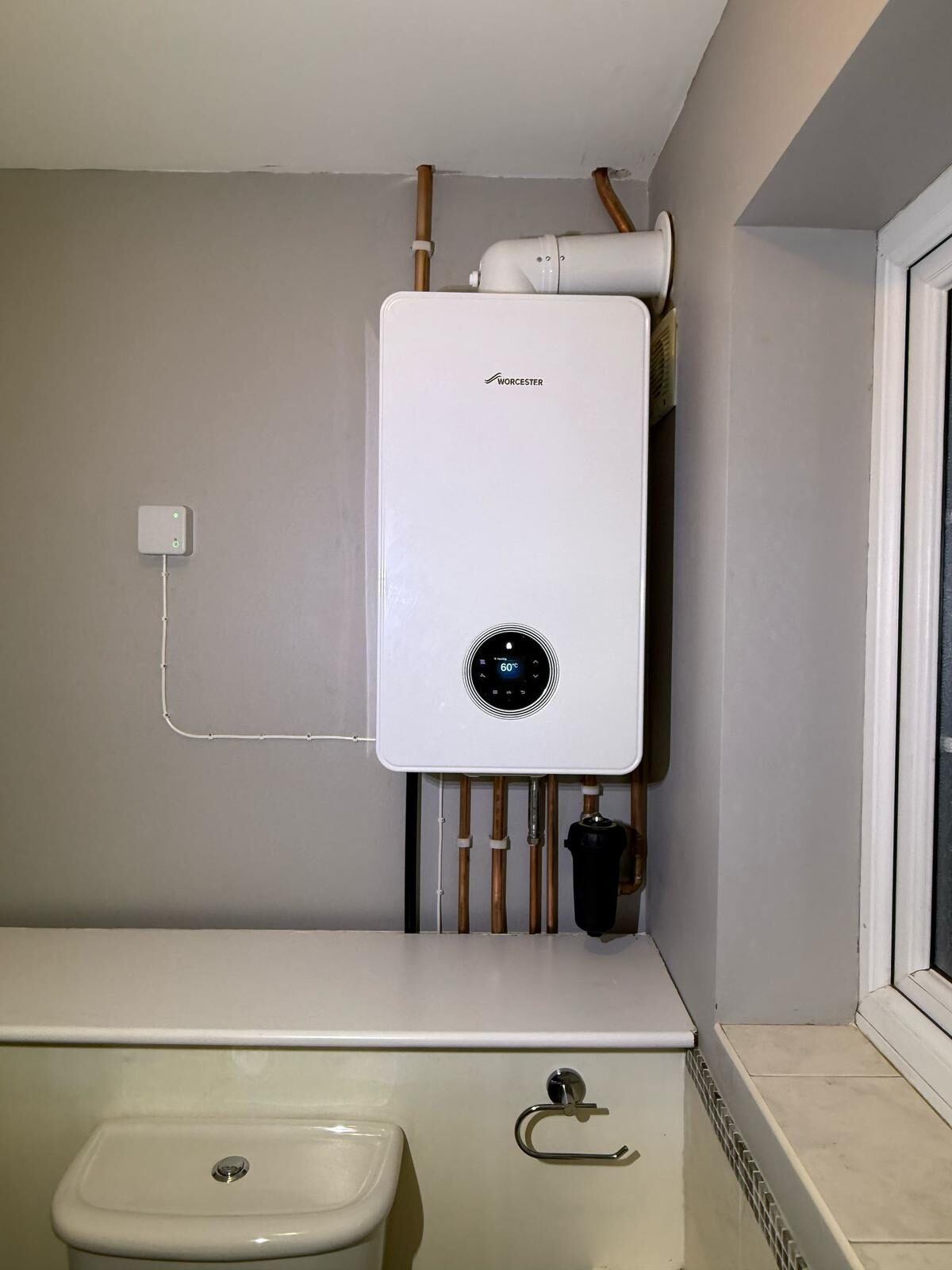 Newly installed wall-hung combi boiler with copper pipework — central heating installation by On-Tap Plumbing & Heating