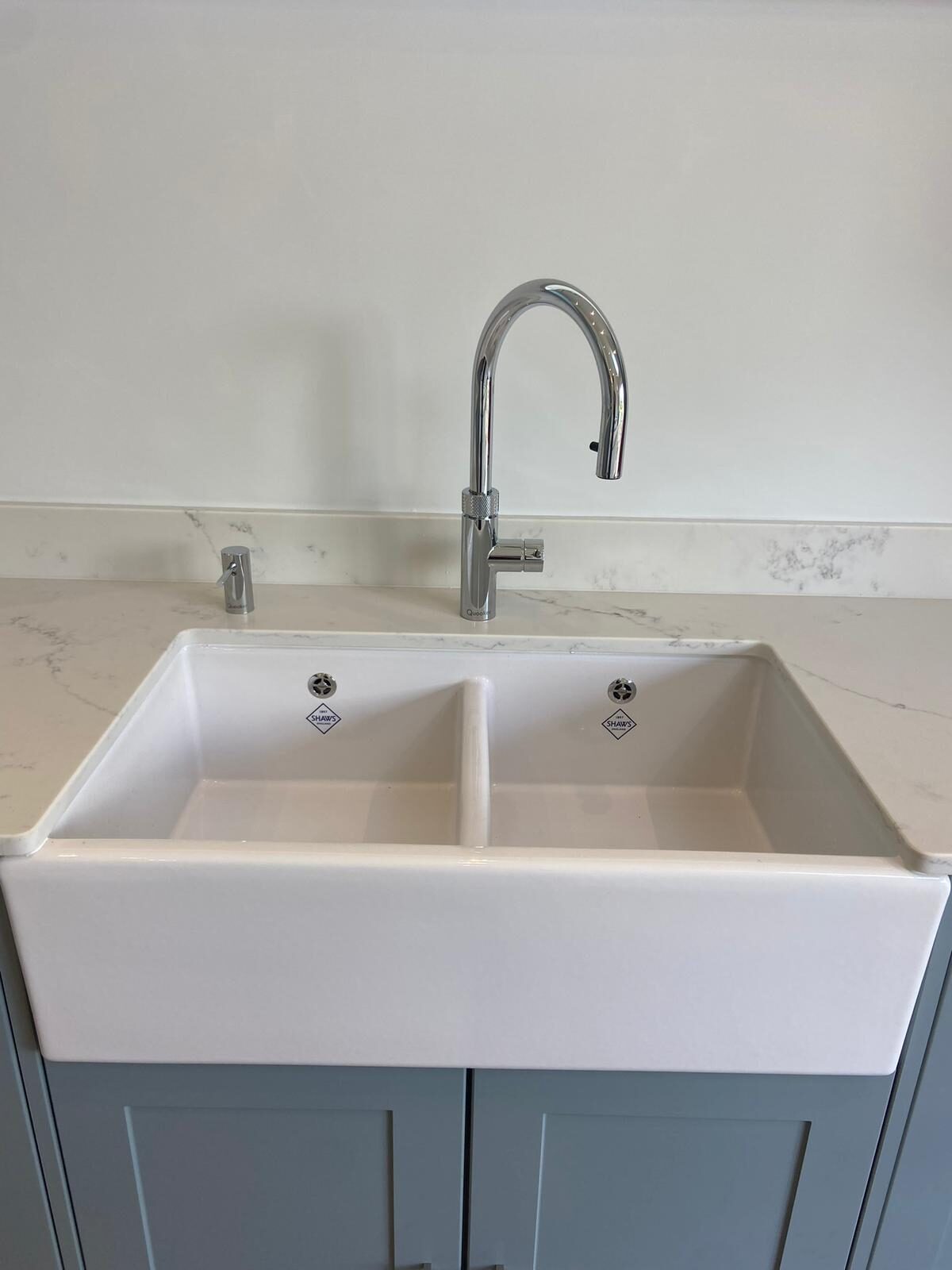 Shaws of Darwen double-bowl Belfast ceramic sink fitted with chrome pull-out mixer tap on marble worktop — kitchen plumbing by On-Tap